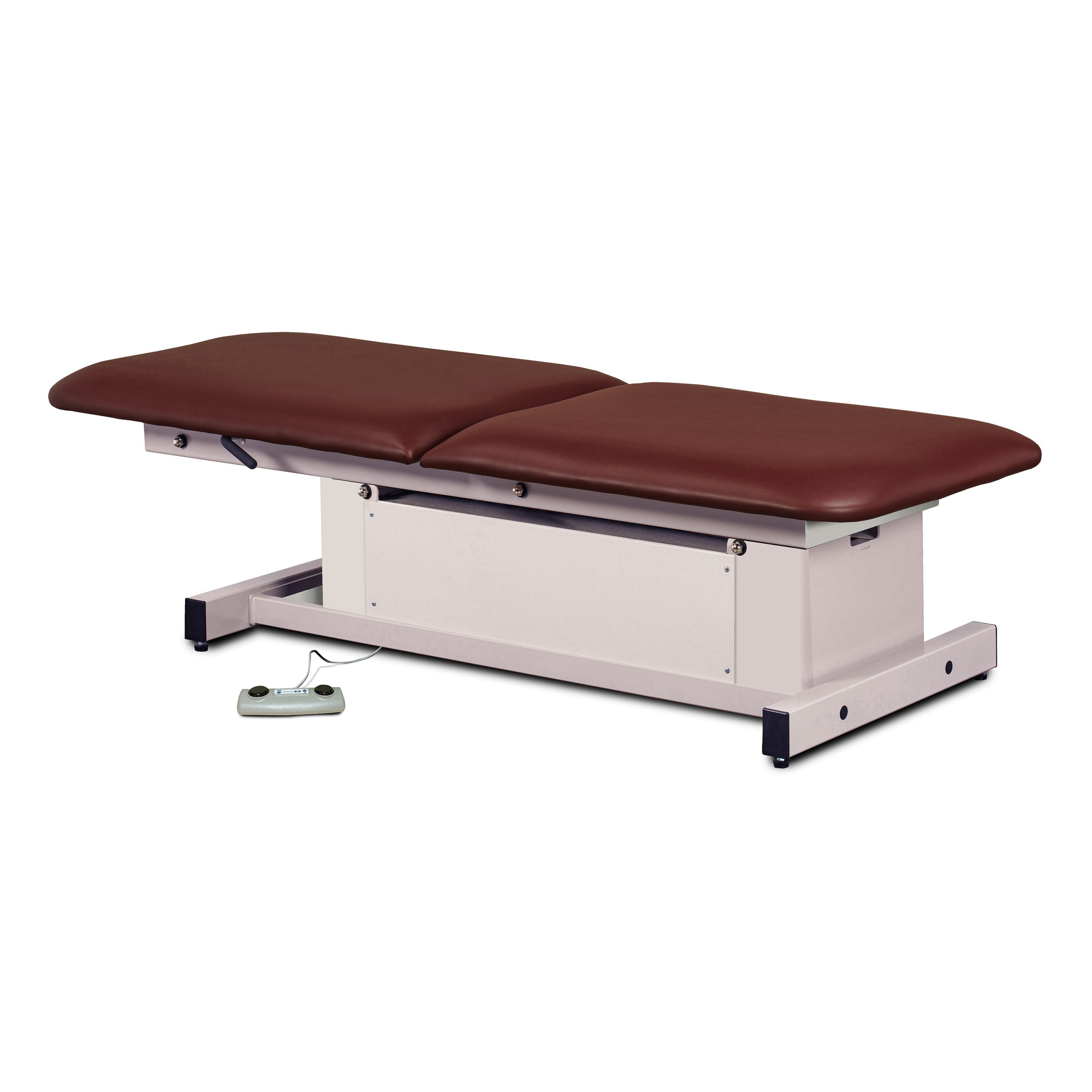 Massage table with brown leather surface and white base on a white background