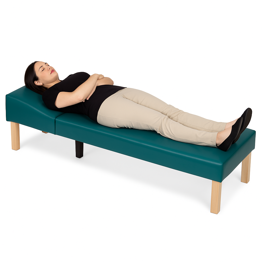 Person lying on a teal massage table with wooden legs on a white background
