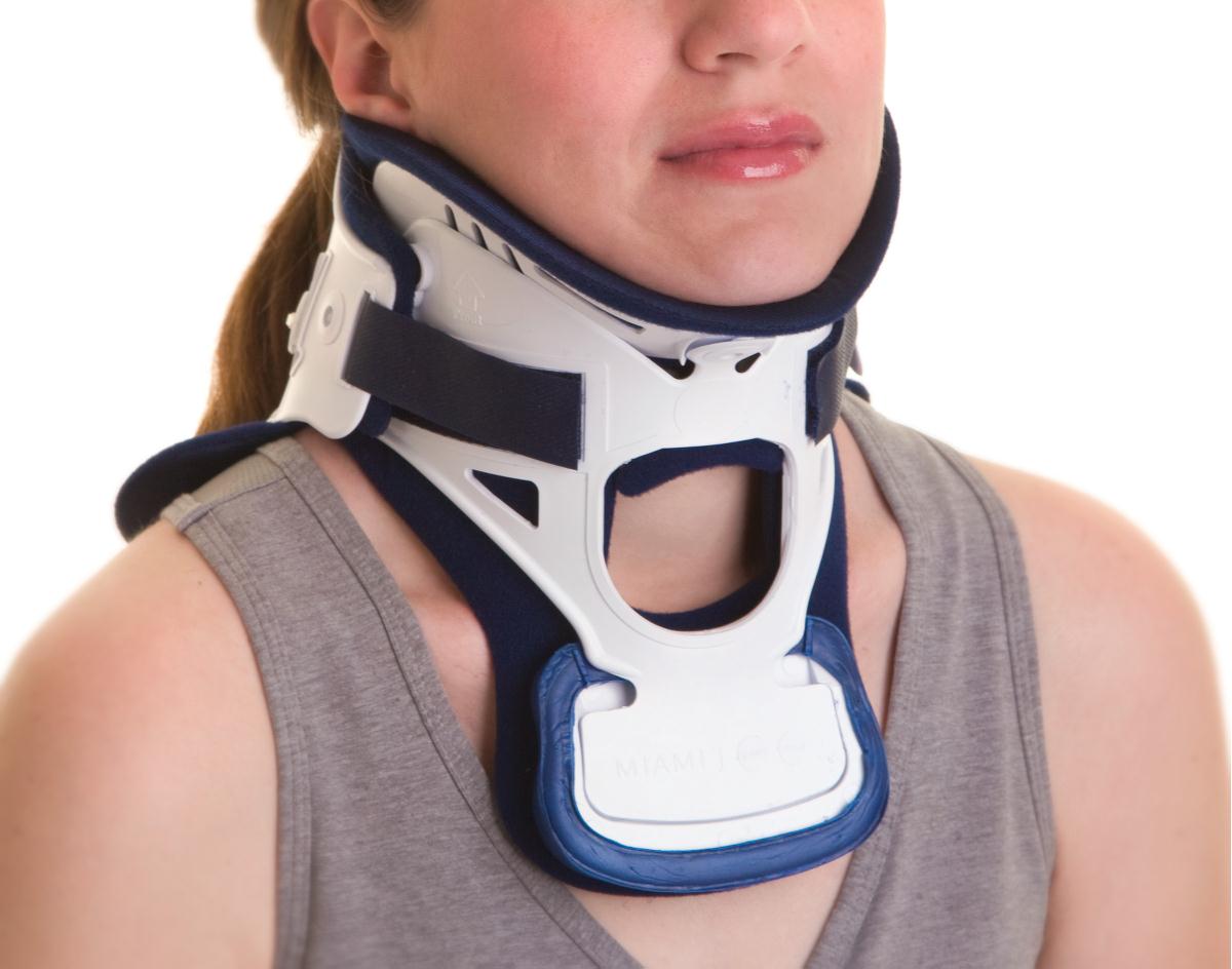 Person wearing a neck brace on a white background