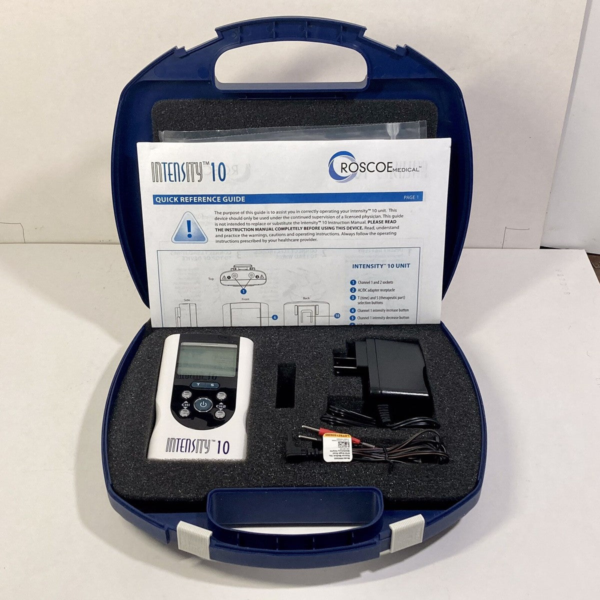 Roscoe Medical Intensity 10 device in a blue carrying case with a quick reference guide.